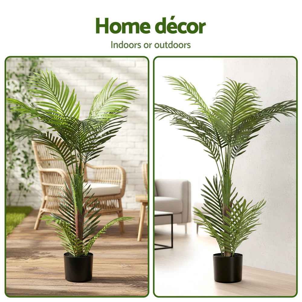 Two artificial palm trees in black pots with green fronds