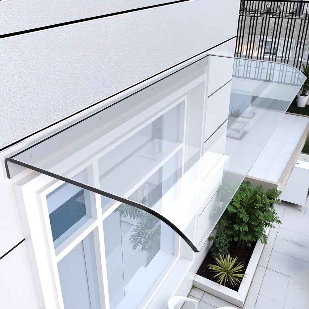 Transparent awning with black metal frame mounted over covered opening