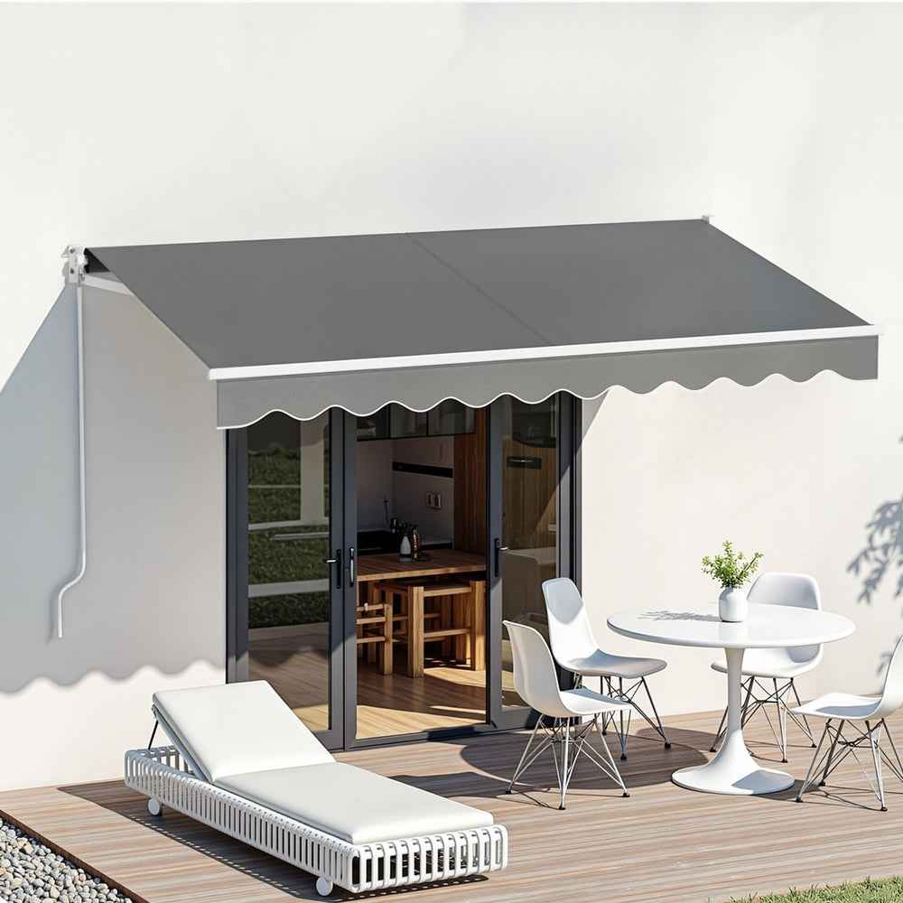 Grey motorised retractable awning over patio opening with scalloped valance