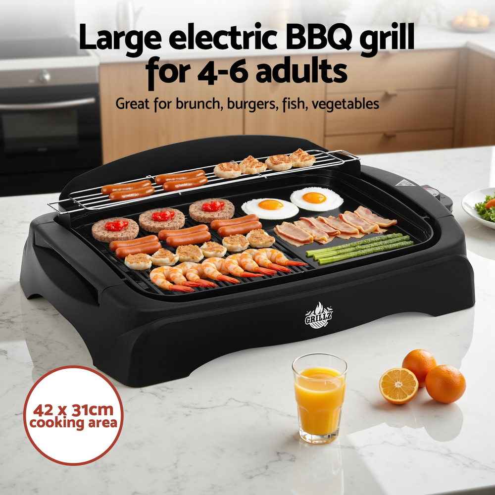 Black electric BBQ grill with wire rack cooking surface and assorted breakfast-style food