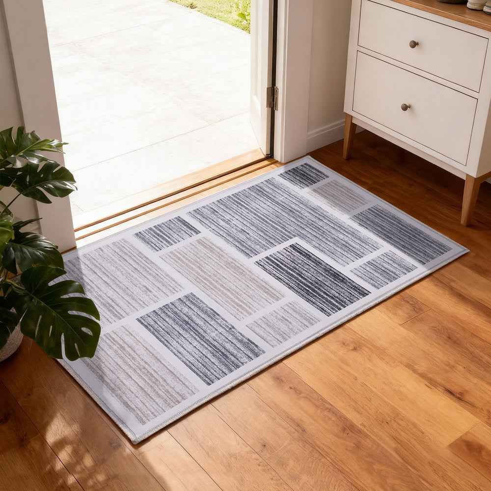 Rectangular floor rug doormat with geometric patchwork in gray and cream tones