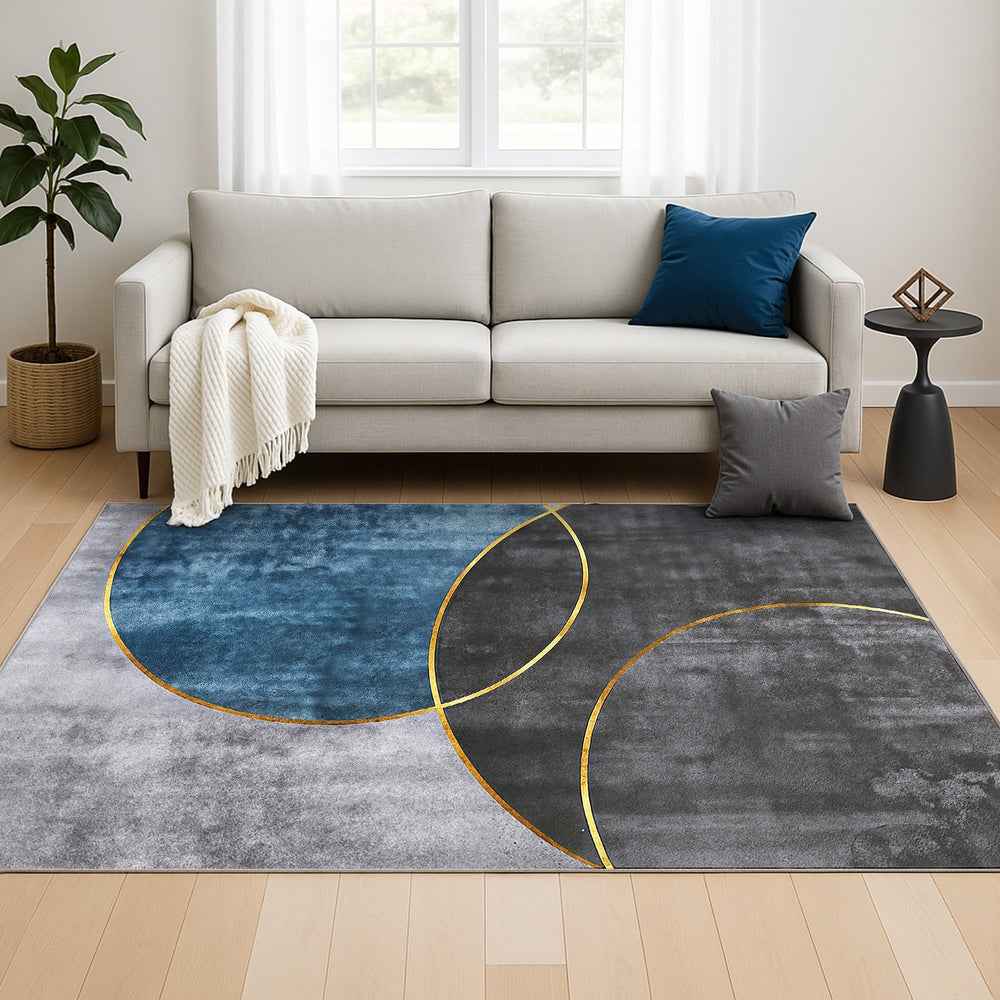 Modern geometric area rug with blue and gray curved ovals and gold border lines
