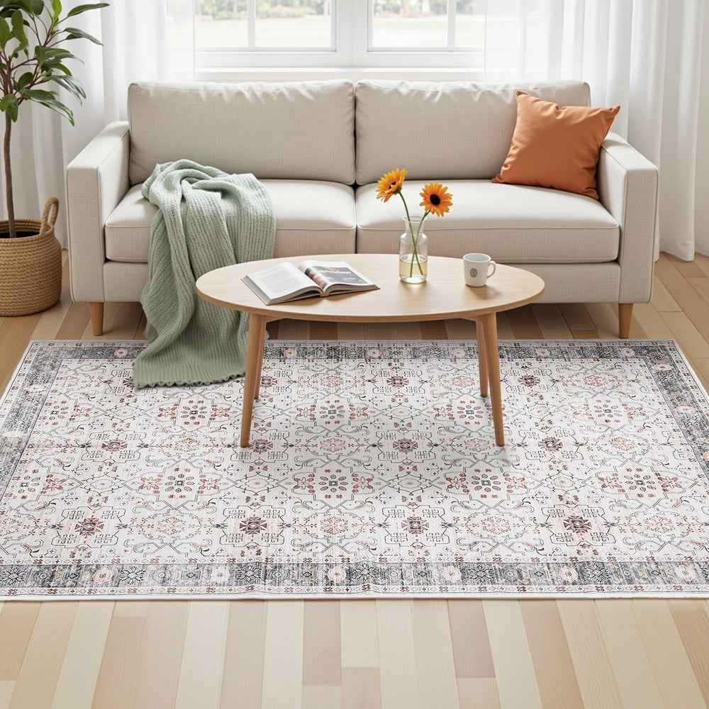 Modern living room area rug with light gray geometric pattern and decorative border