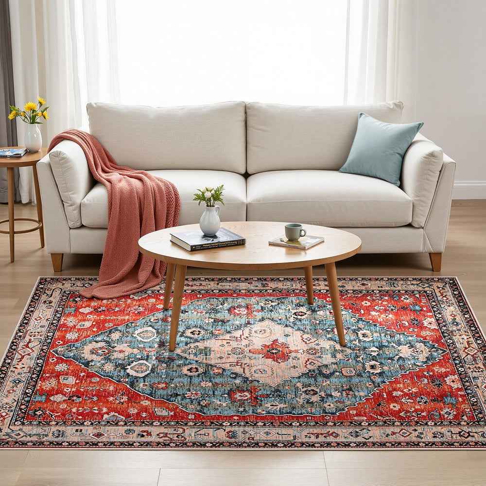 Large vintage medallion area rug in a living room with red, blue, and cream pattern