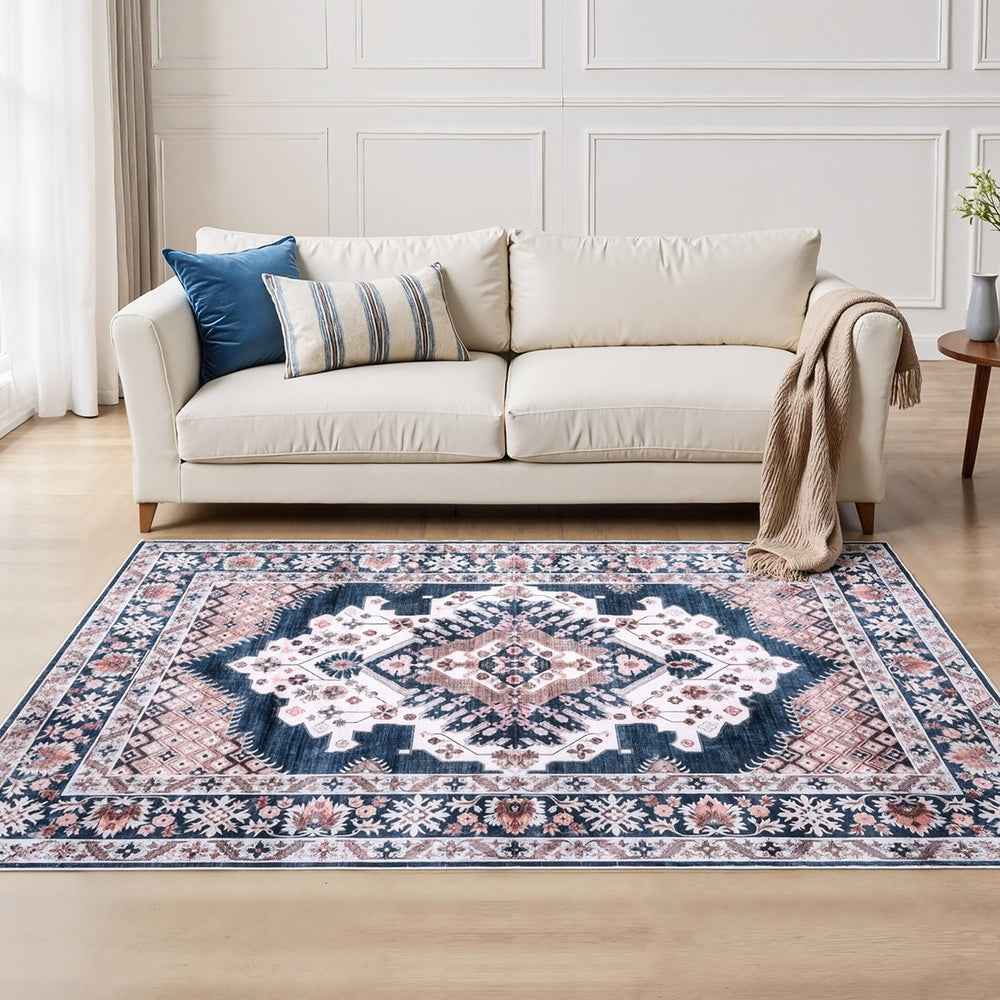 Persian-style area rug with navy center medallion and ornate cream border on floor