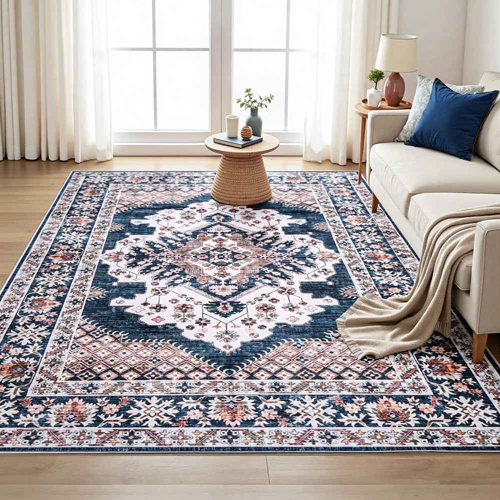 Persian-style area rug with navy center medallion, cream border and pink accents