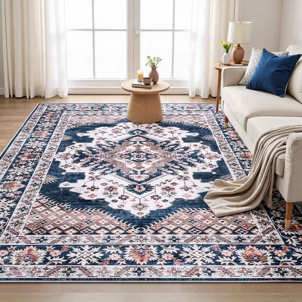 Persian-style area rug with navy, cream, and pink floral geometric design and border
