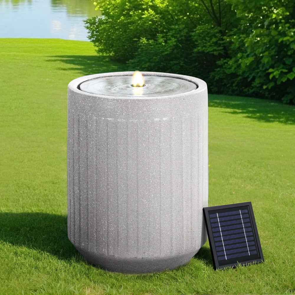 Gray solar LED water fountain cylinder with glowing top and solar panel on lawn