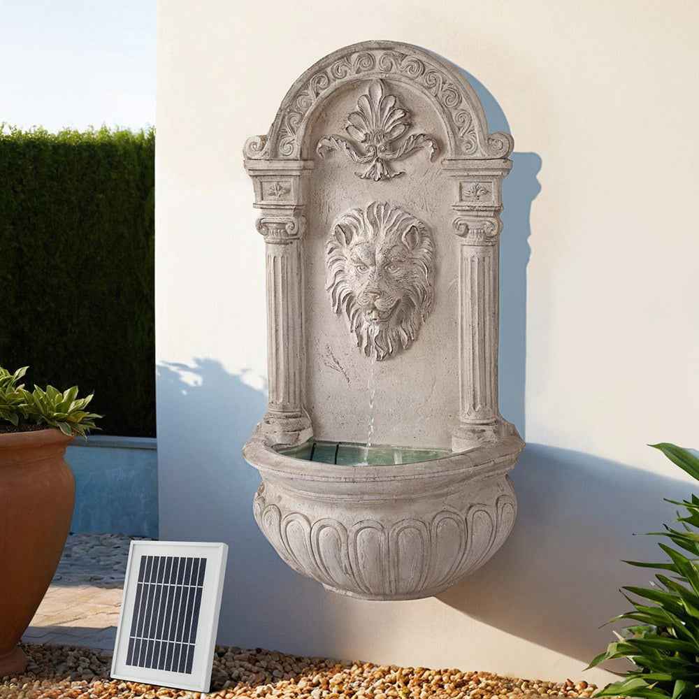 Beige lion-head solar fountain with arched relief and small solar panel accessory