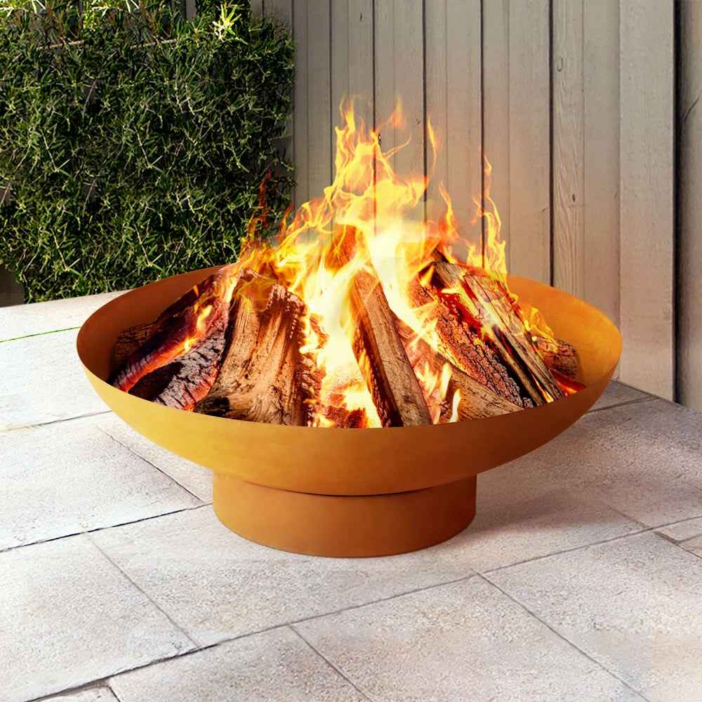 Round orange-brown fire pit bowl with burning logs and bright flames