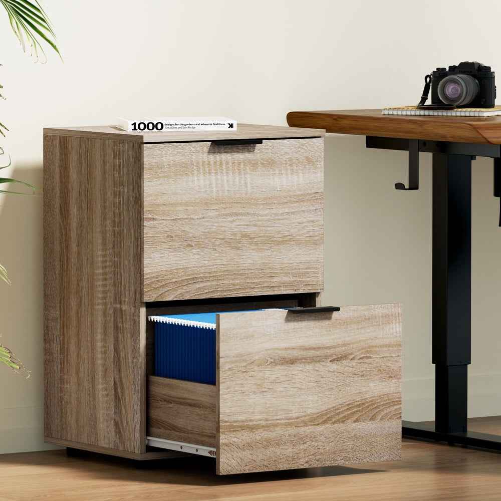 Oak 2-drawer filing cabinet with top drawer closed and bottom drawer open.