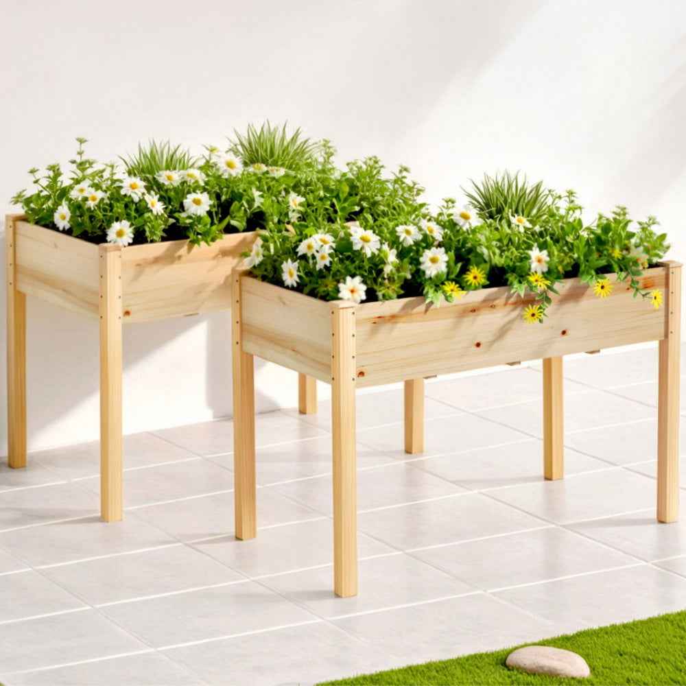 Two raised wooden planter boxes with flowers and greenery, black interior beds