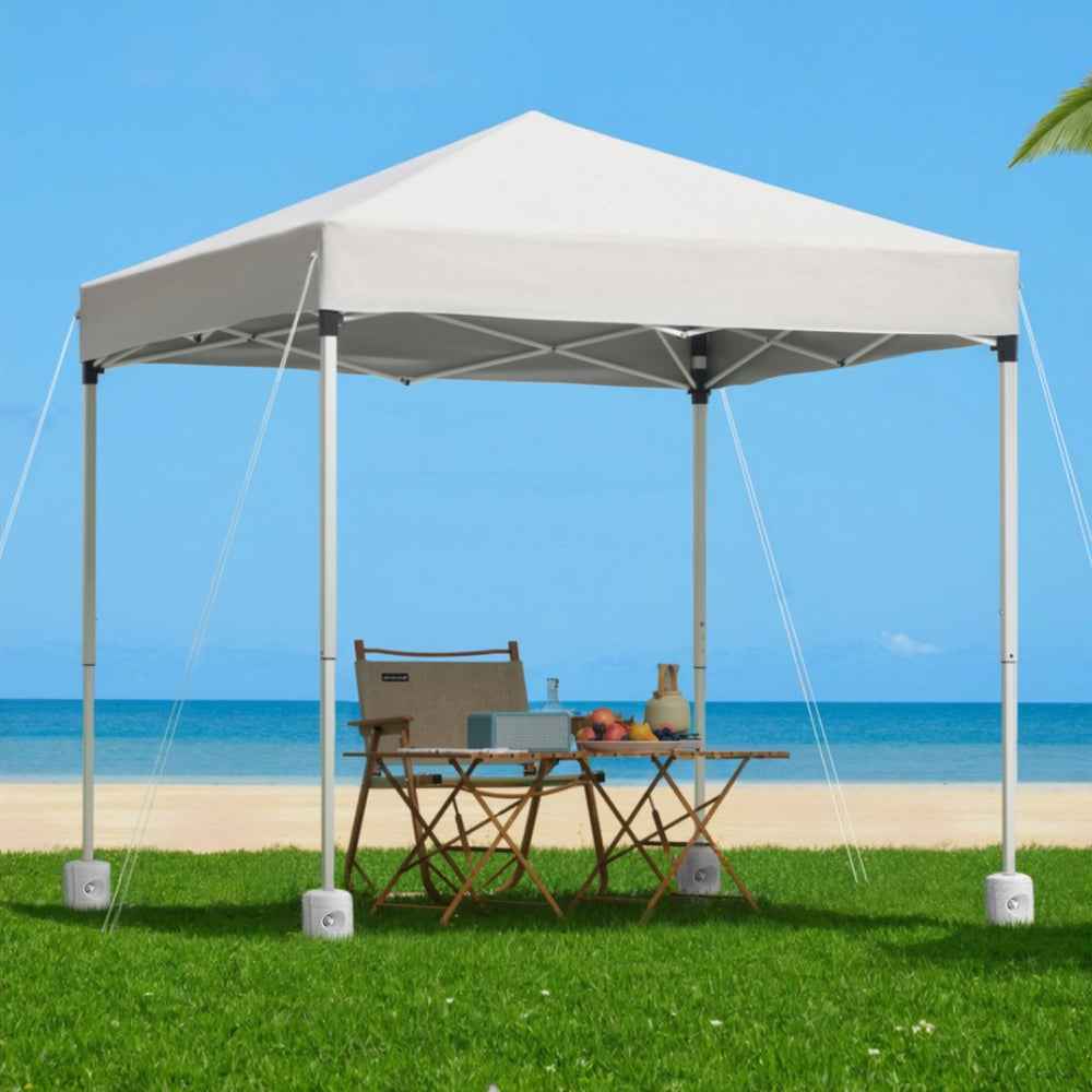 White square outdoor gazebo with four posts, hanging base pods, and open canopy