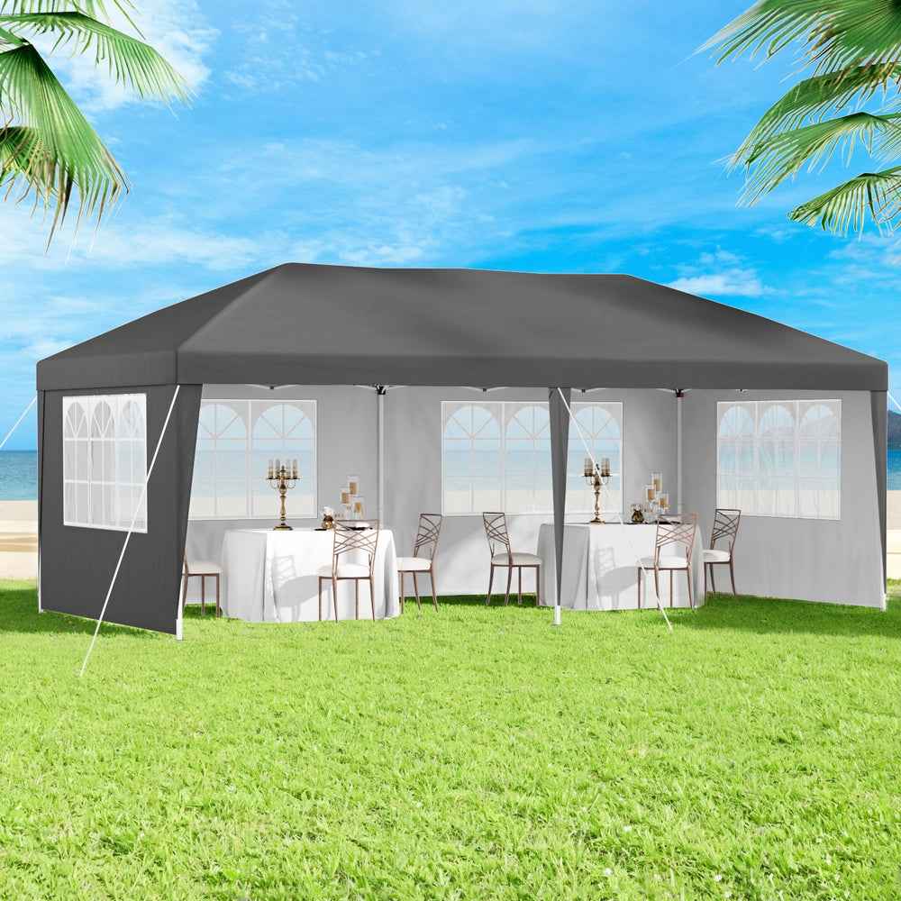 Grey pop-up gazebo with mesh window curtains and open sides on grass