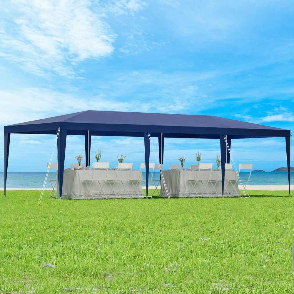 Blue outdoor gazebo marquee tent covering a table and chairs setup