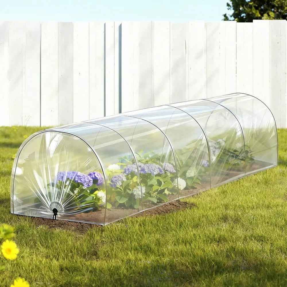 Clear PVC tunnel greenhouse with arched steel hoops and open end