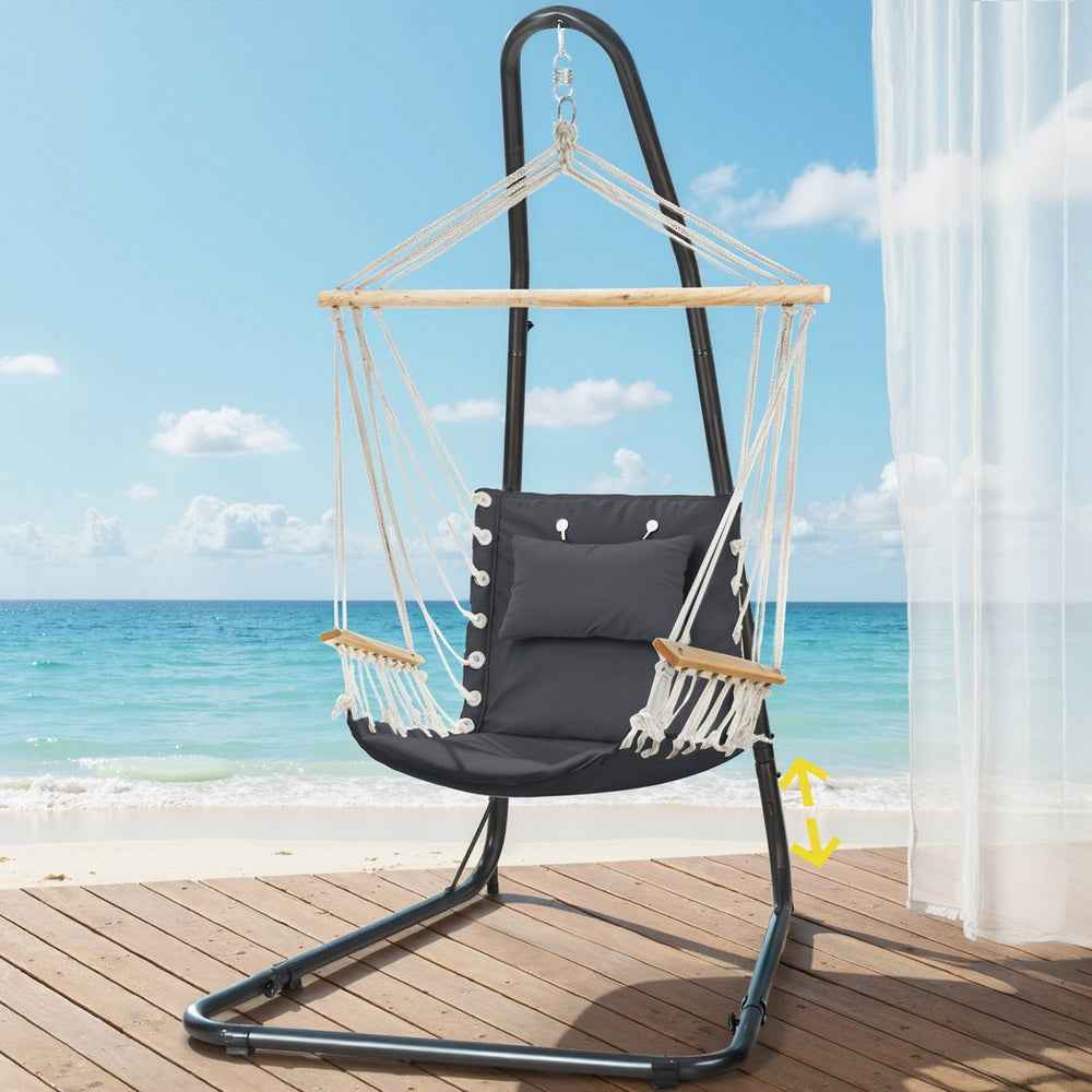 Hammock chair with black steel stand, dark seat cushion, white rope net, hanging wooden bar