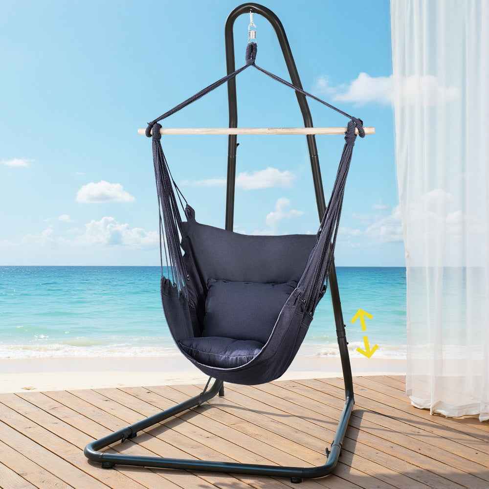 Navy hammock chair with steel stand on deck, hanging seat with wooden spreader bar.