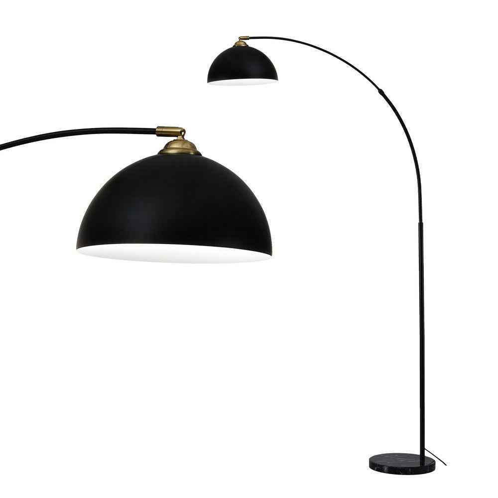 Black arched floor lamp with dome shade, brass top finial, and round base