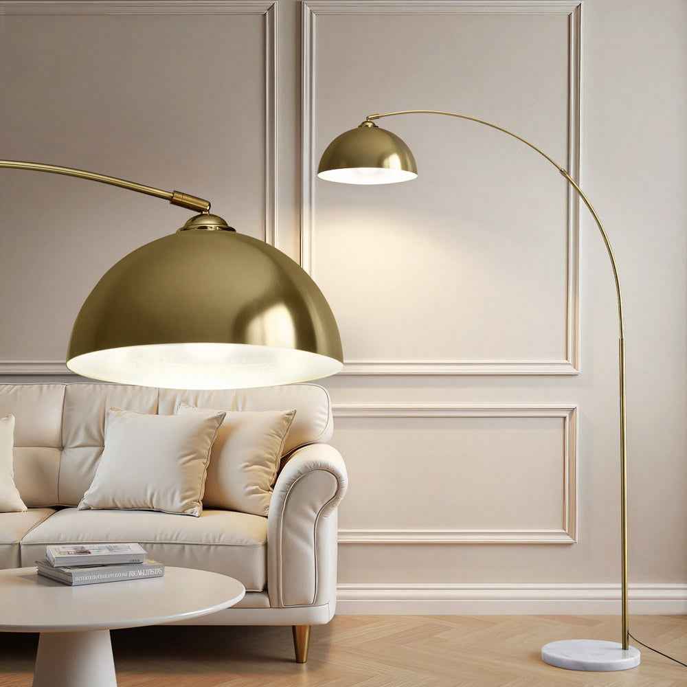 Gold arched floor lamp with wide dome shade and round marble base
