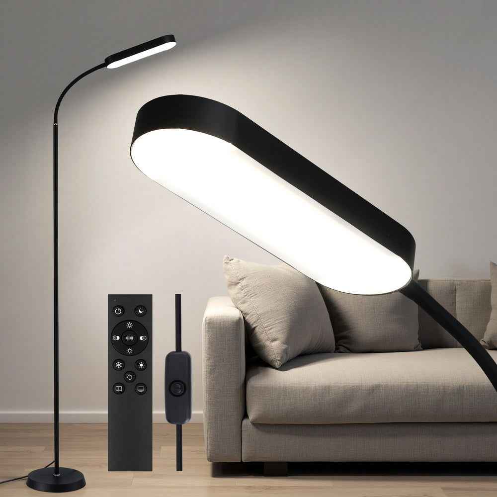 Black LED floor lamp with arched light bar and remote control on living room base