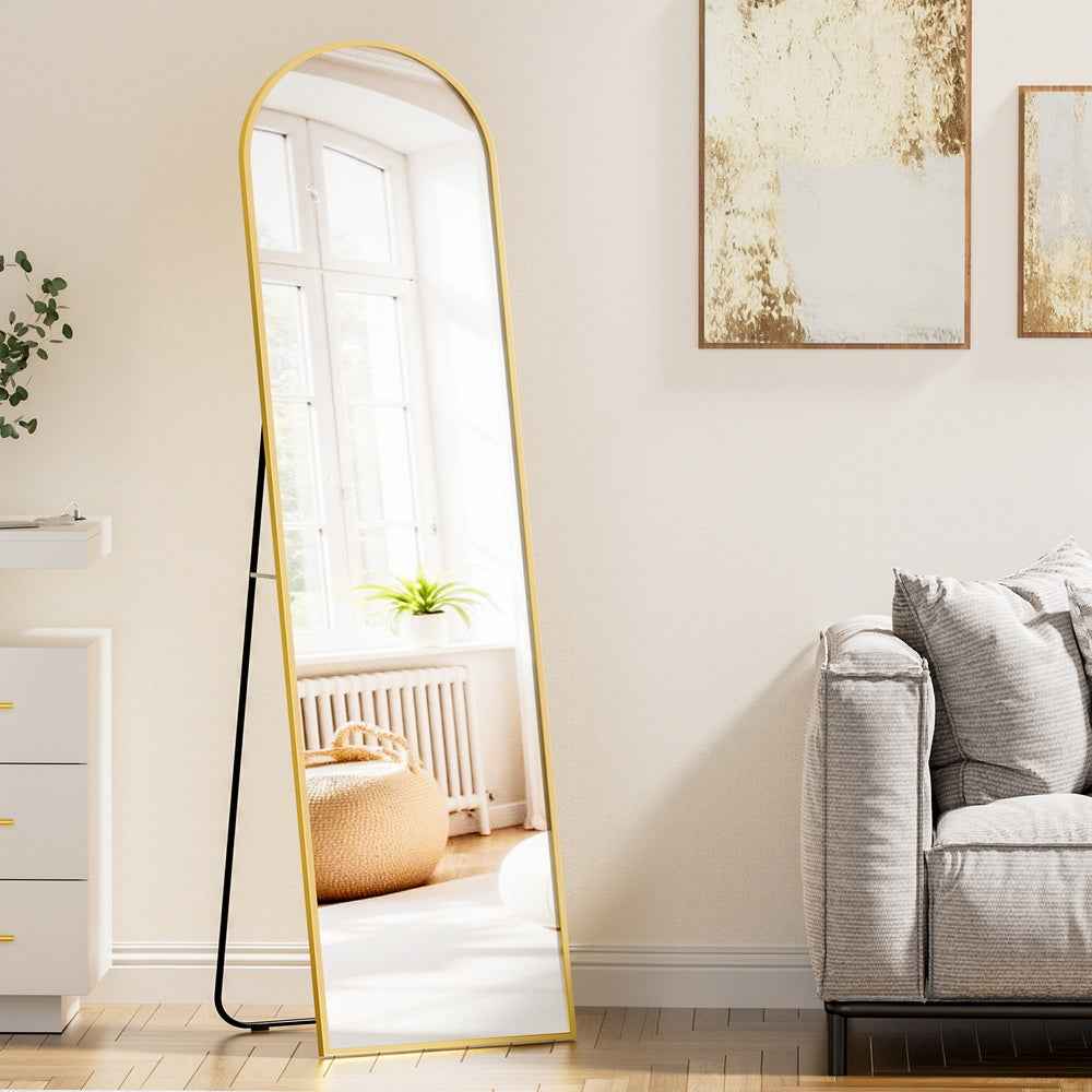 Full-length floor mirror with arched top, gold-tone frame, and black base