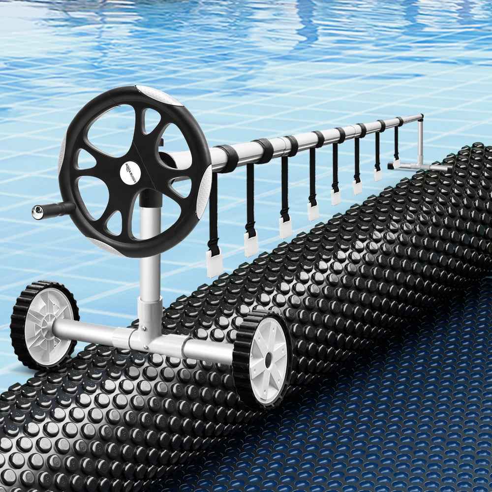 Black solar pool cover with bubble texture and roller handle system