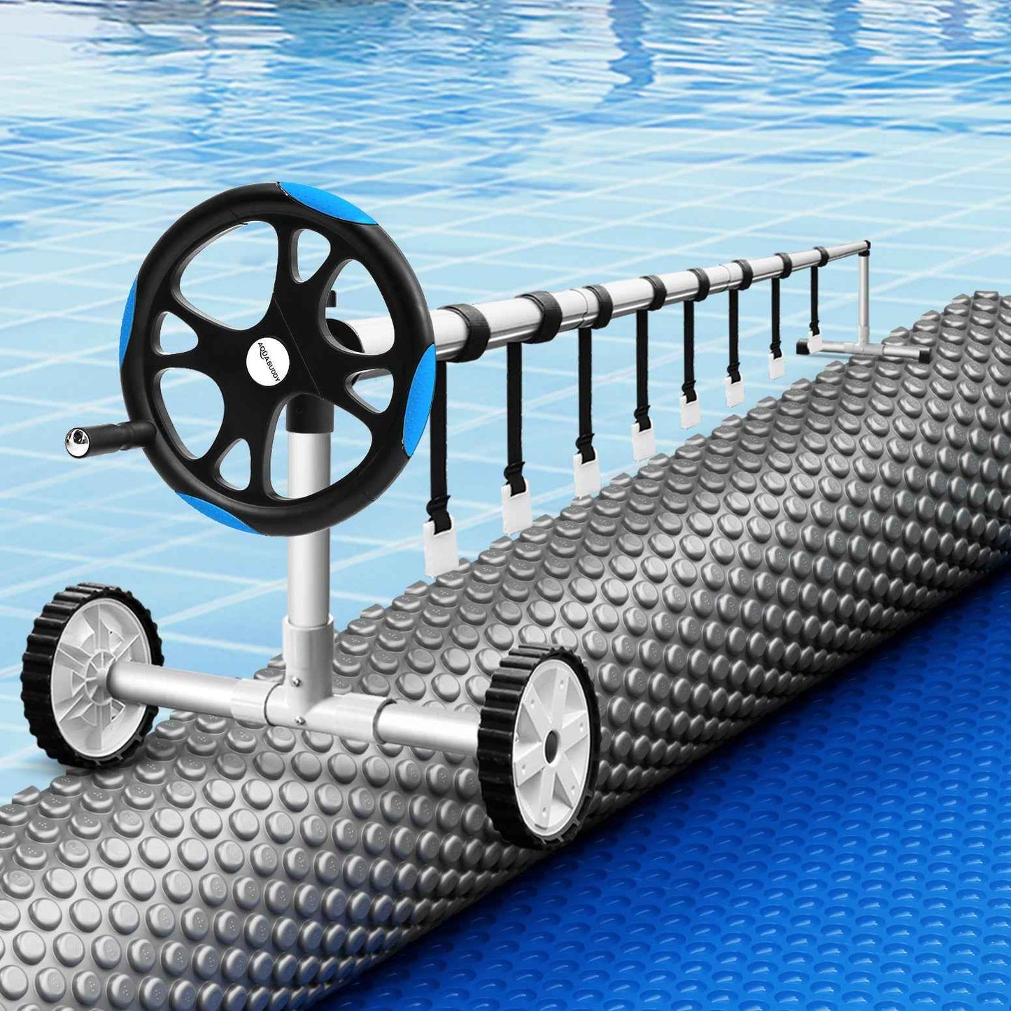 Blue solar pool blanket rolled on a system with black wheel and bubble-textured cover