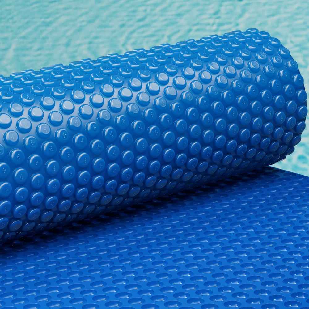 Blue pool solar blanket with raised bubbles on an overlapping folded layer