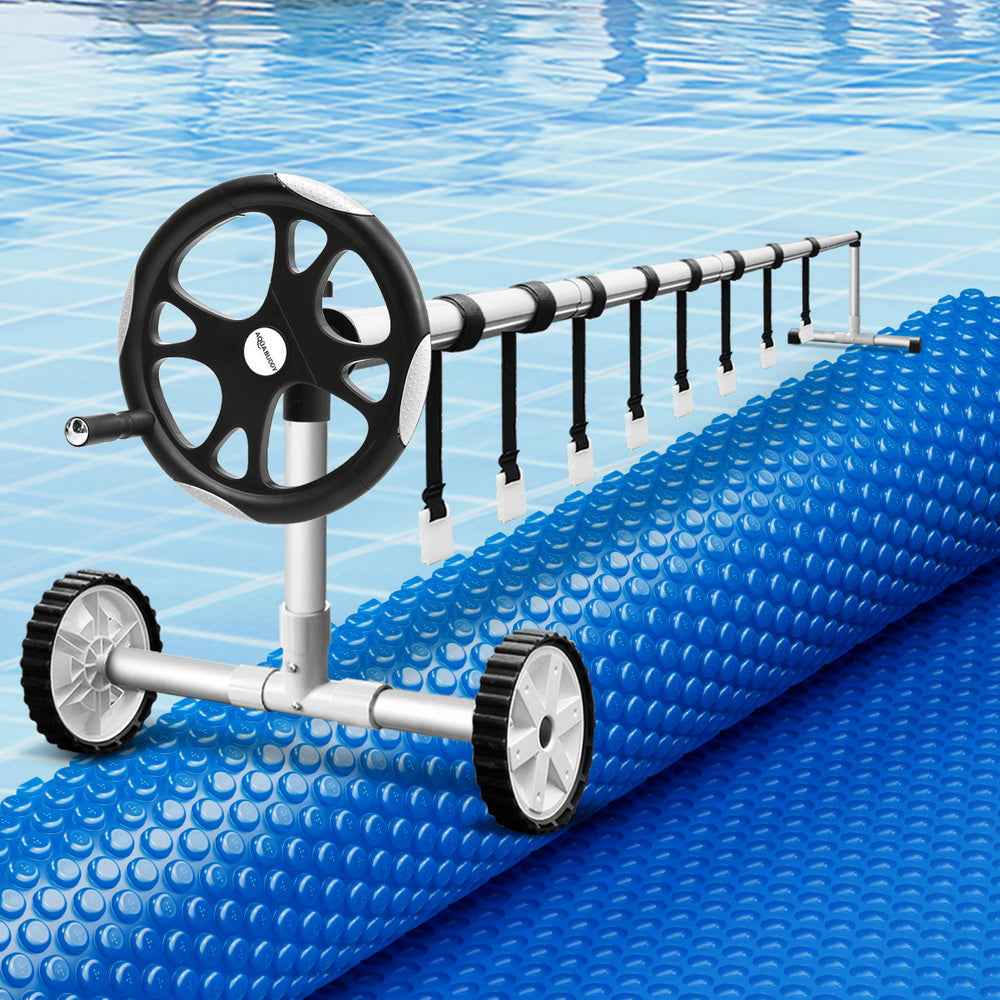 Blue solar pool cover with bubble texture and roller winder with black wheels