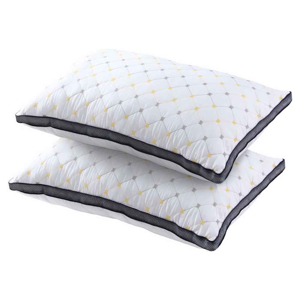 Set of 2 microfibre pillows, white with yellow pattern and dark piped edges, stacked