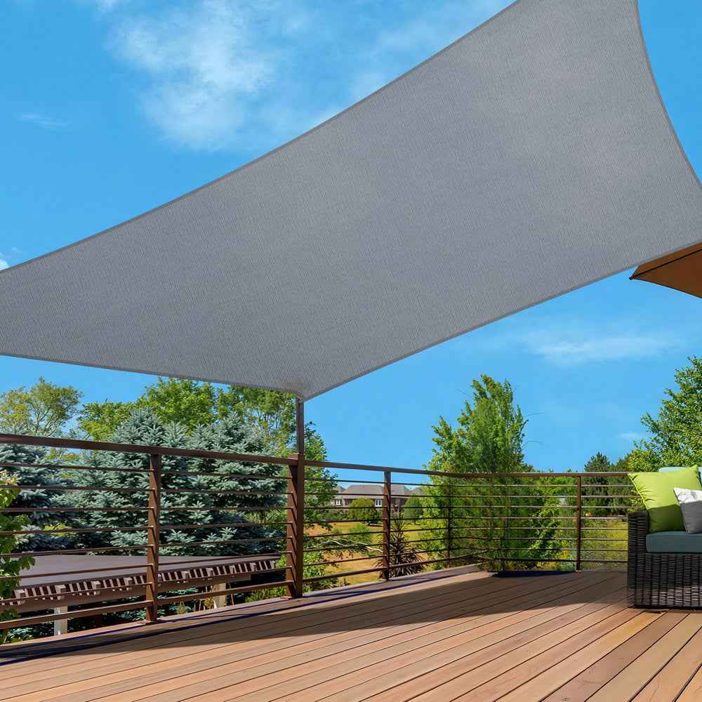 Gray rectangle sun shade sail canopy attached over an outdoor deck