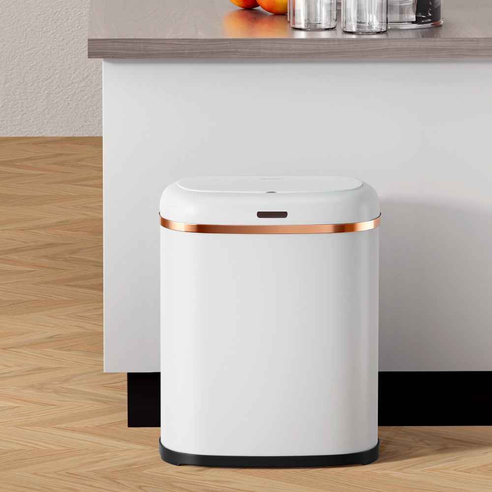 White automatic motion sensor bin standing on floor with copper-trim lid