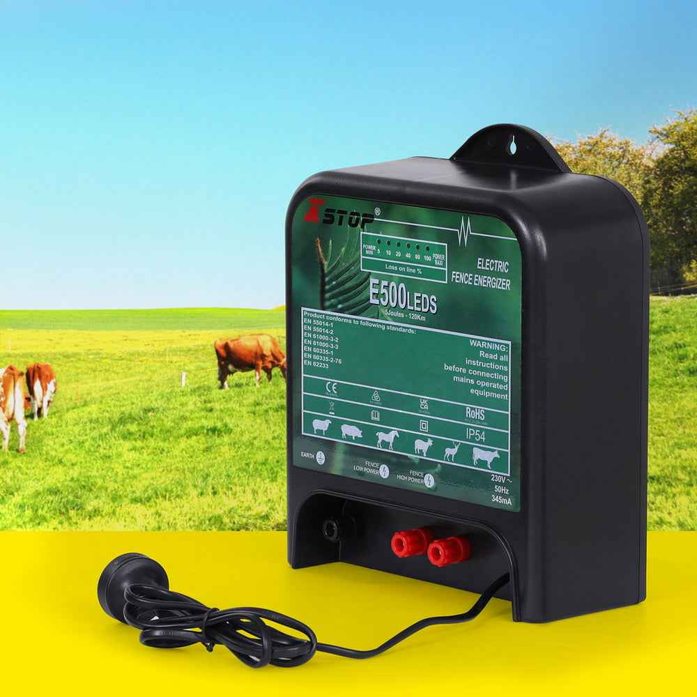 Electric fence energiser with black housing, green label, red output terminals, and power cord