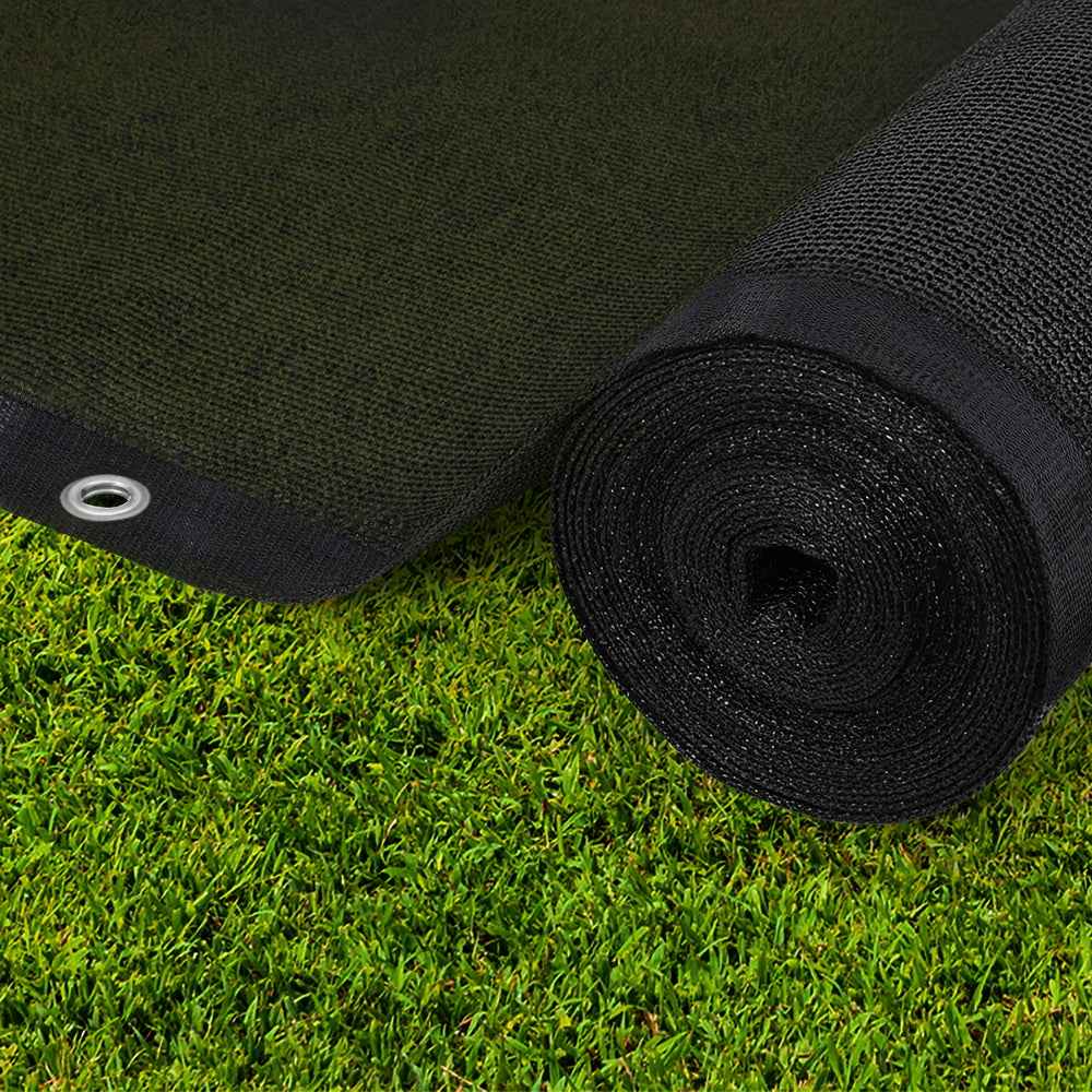 Black shade cloth roll with grommeted edge on green grass