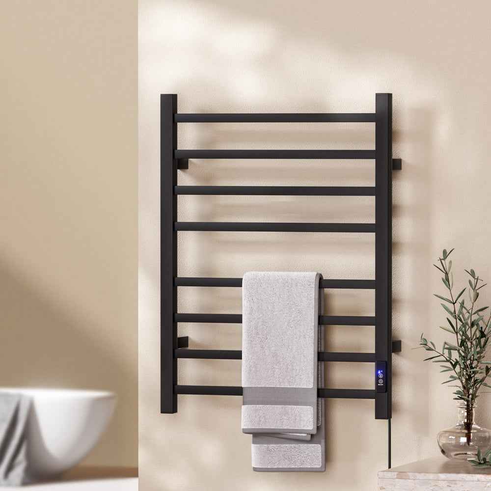 Black heated towel rail with square bars, towels neatly placed on rack