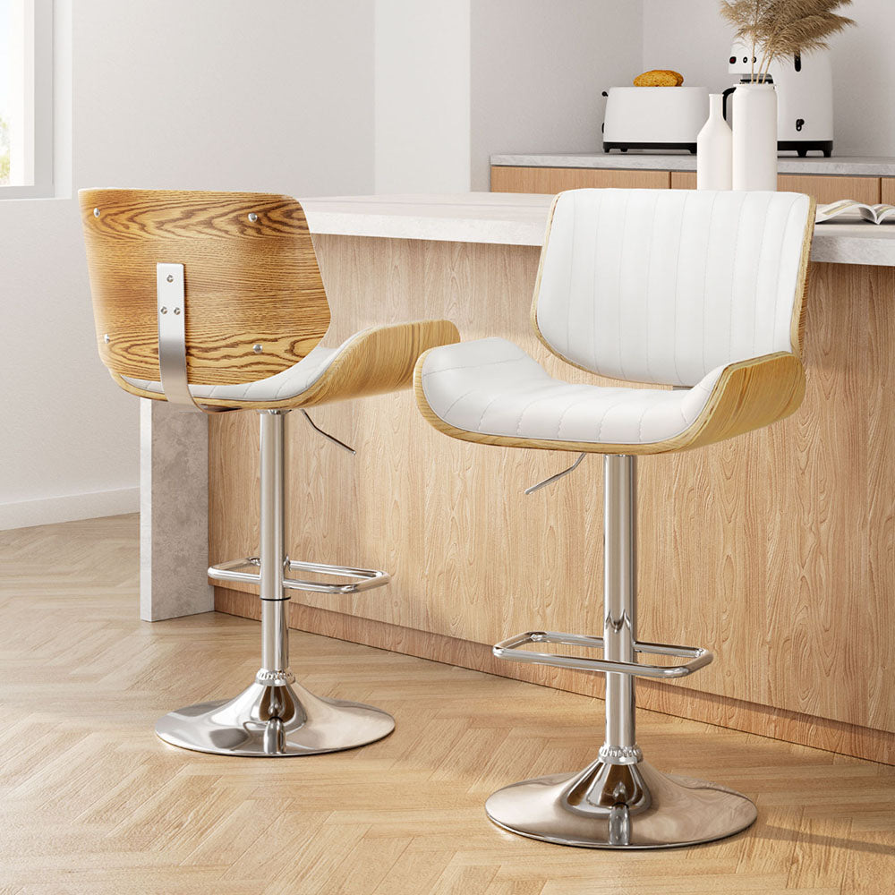 Pair of adjustable bar stools with white cushioned seats, light wood sides, chrome base