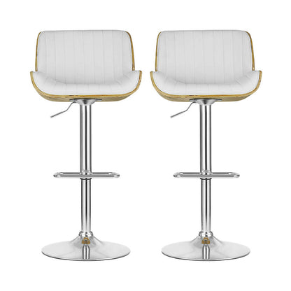 Set of two white upholstered bar stools with light wood armrests and chrome pedestal base