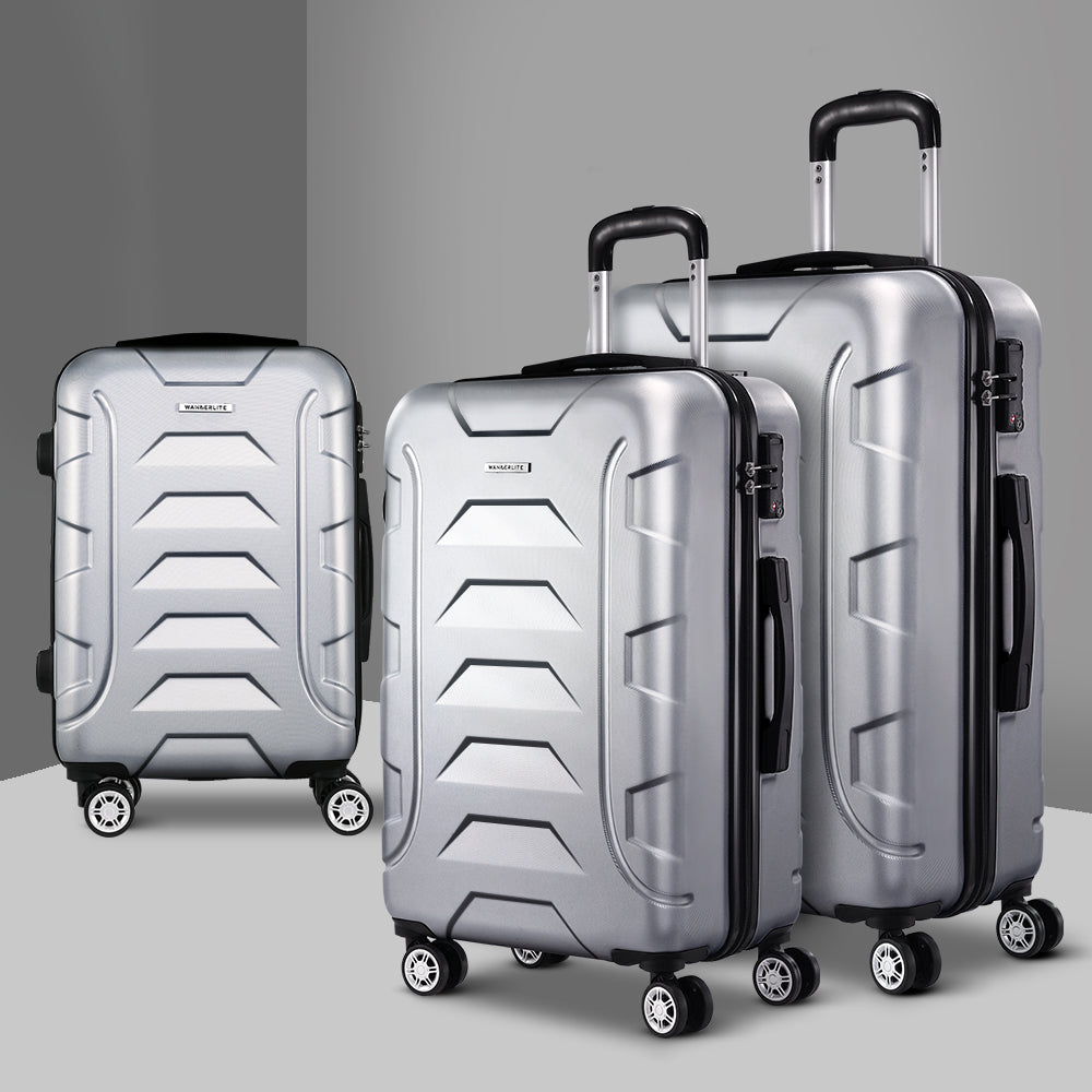 Silver hard-shell spinner luggage set with three suitcases and upright telescoping handles