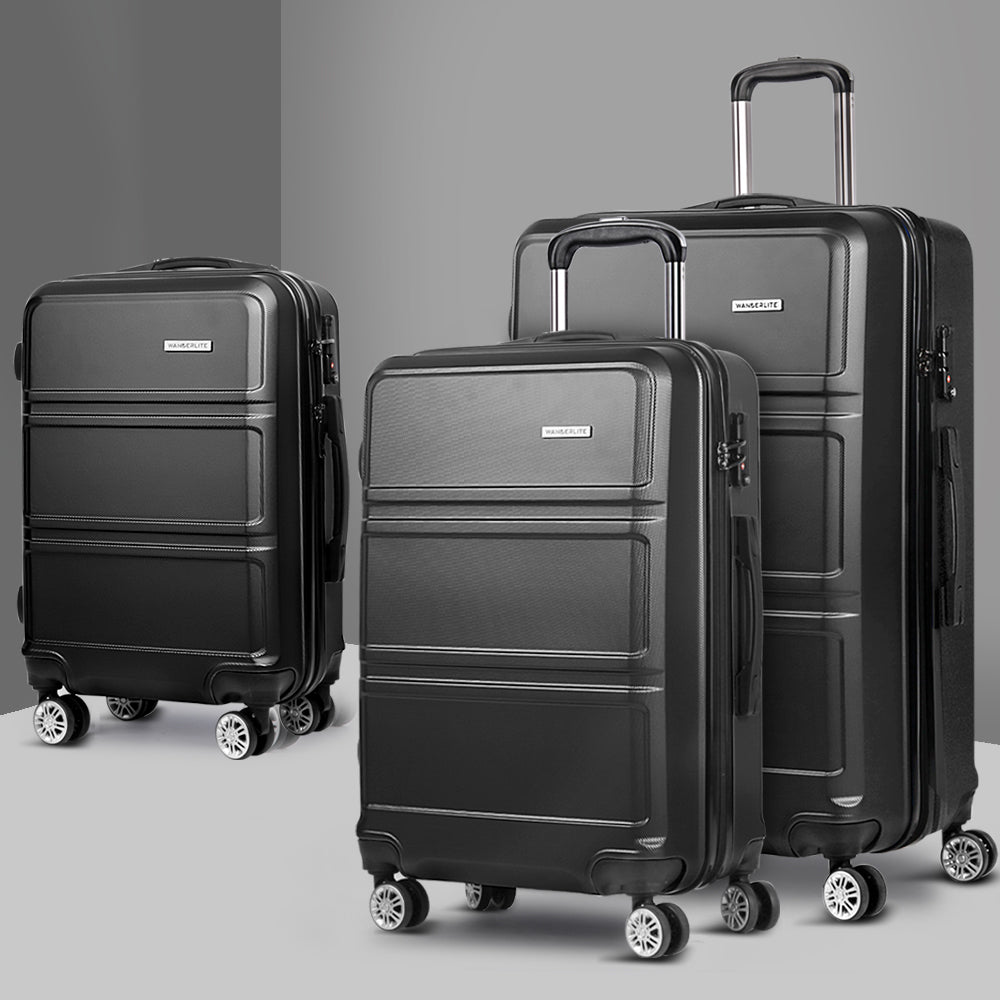 Set of three black hard-shell spinner suitcases with telescoping handles and side pockets