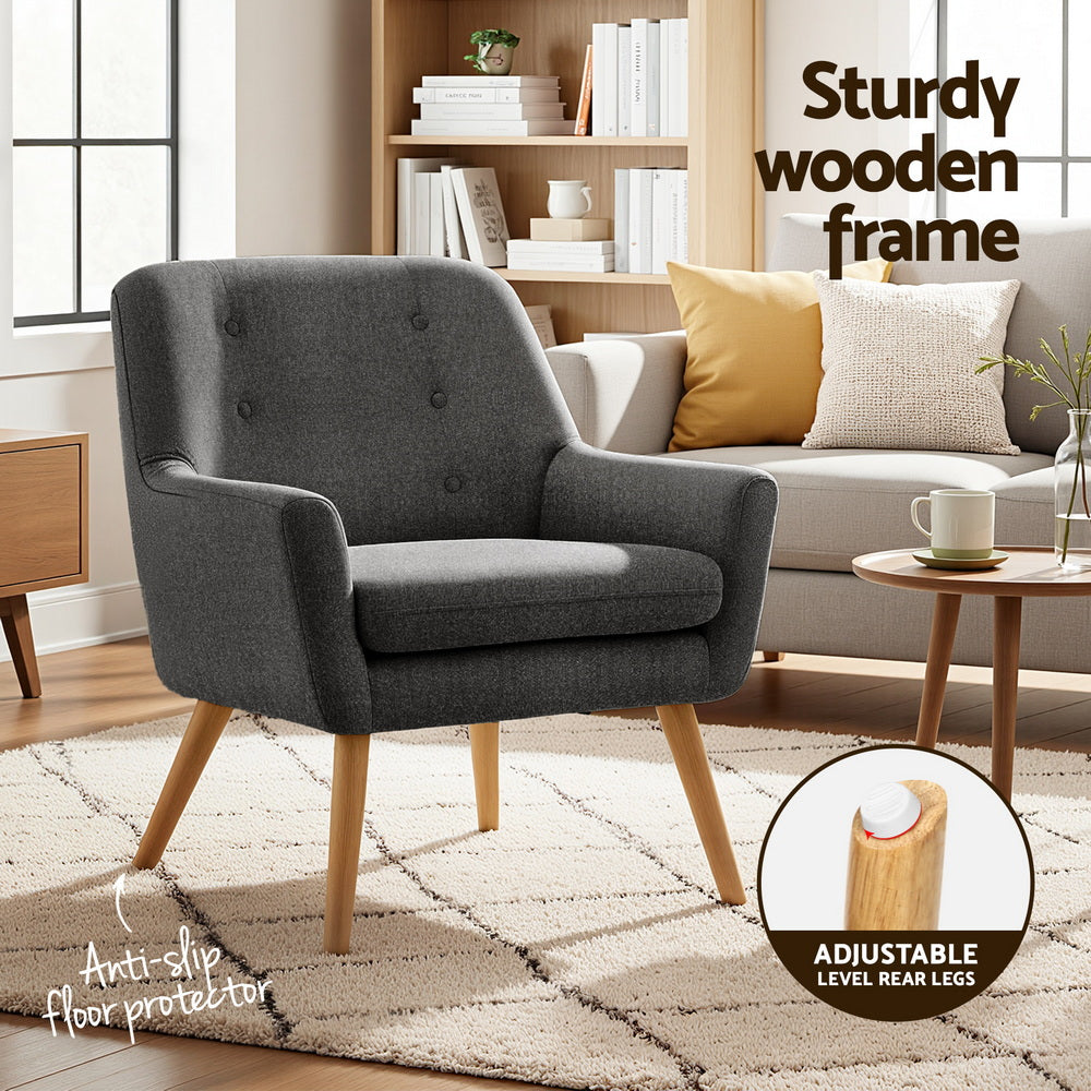 Charcoal upholstered accent chair with button-tufted back, rolled arms, wooden legs